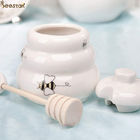 pot de miel de porcelaine et pot blanc en céramique de miel de cuillère avec le couvercle